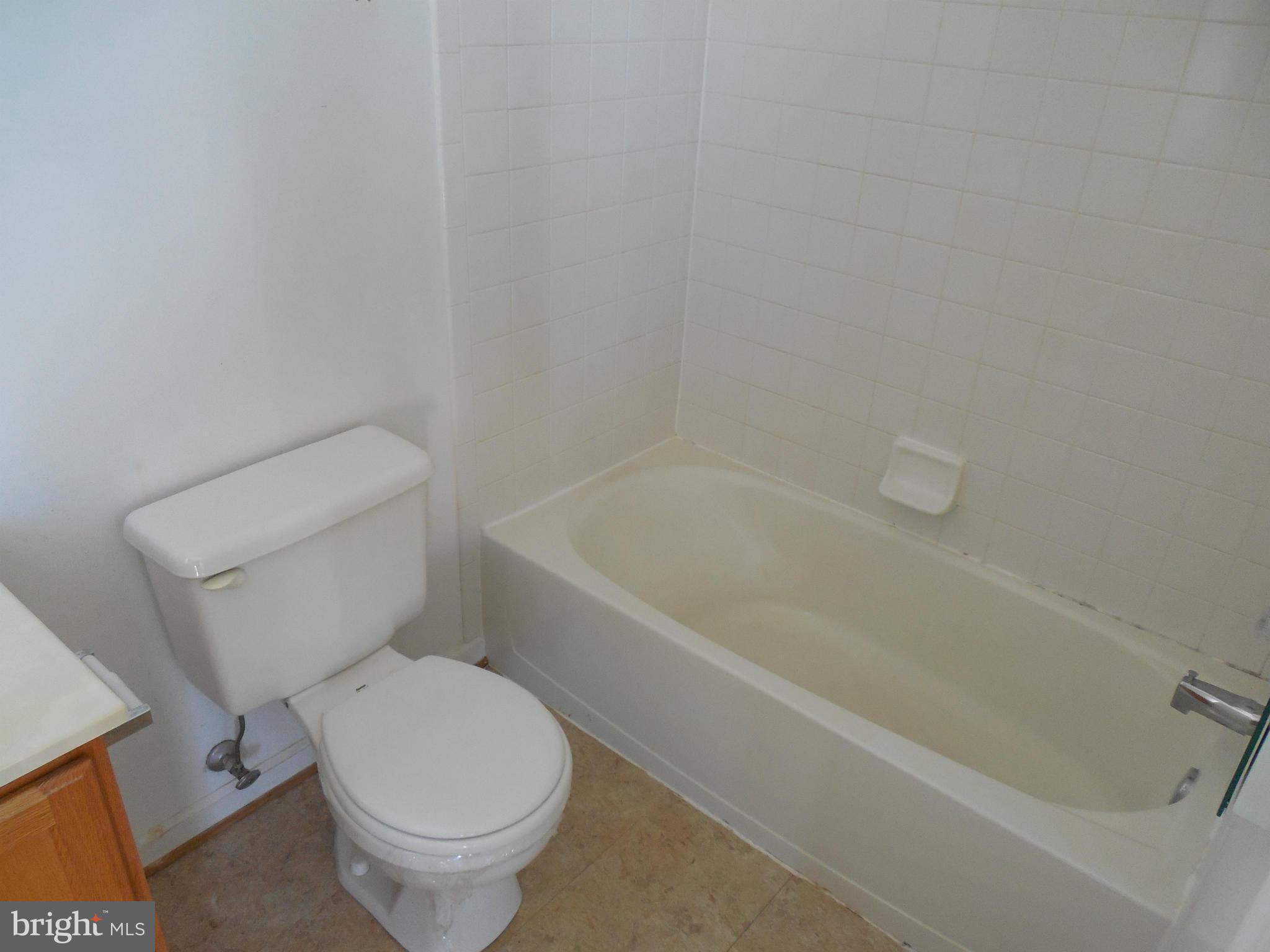 5540 Upshur Square Frederick, MD 21703 - Photo 8 of 8 a white toilet sitting next to a bath tub
