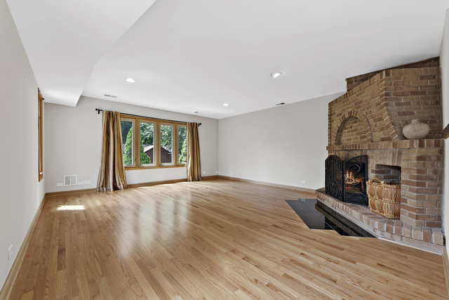 1736 Evergreen Lane Park Ridge, IL 60068 - Photo 14 of 37 a view of an empty room with wooden floor fireplace and a window