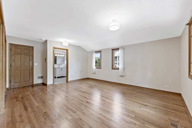 1736 Evergreen Lane Park Ridge, IL 60068 - Photo 19 of 37 an empty room with wooden floor and windows