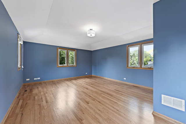1736 Evergreen Lane Park Ridge, IL 60068 - Photo 23 of 37 a view of a big room with windows and wooden floor