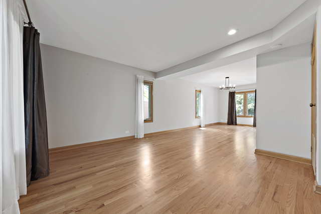 1736 Evergreen Lane Park Ridge, IL 60068 - Photo 6 of 37 a view of an empty room with wooden floor and a window