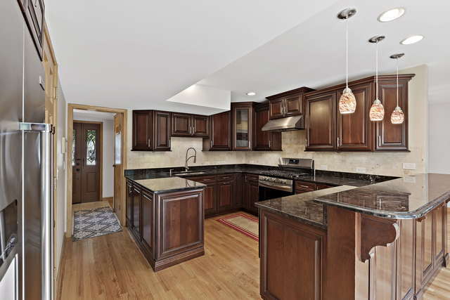 1736 Evergreen Lane Park Ridge, IL 60068 - Photo 8 of 37 a kitchen with stainless steel appliances granite countertop a stove a sink dishwasher and a refrigerator with wooden floor