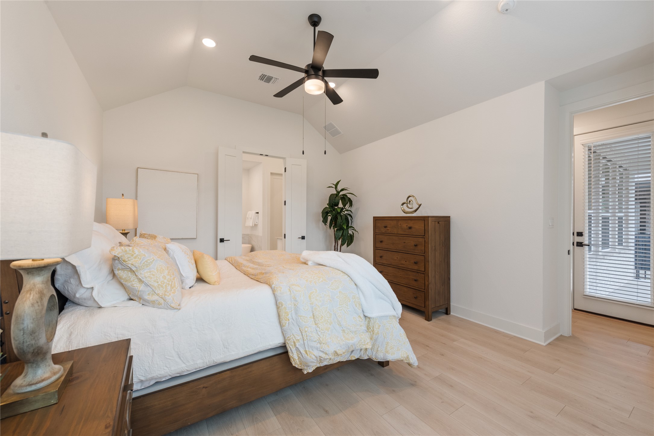 294 Kimble Creek Loop Kyle, TX 78640 - Photo 15 of 40 Relax in this well-lit bedroom featuring high vaulted ceilings and light wood flooring.