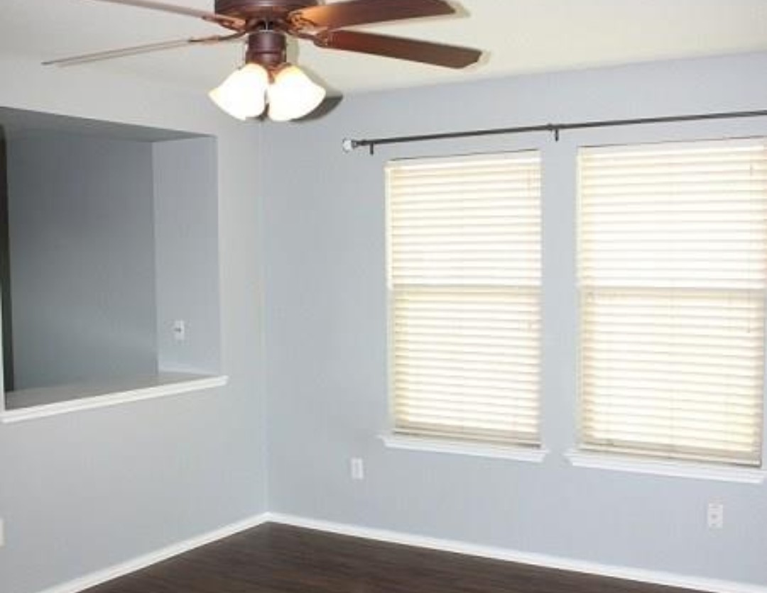 1120 Apollo Circle Round Rock, TX 78664 - Photo 7 of 14 Room featuring a ceiling fan with integrated lighting, wood-finish flooring, and light gray walls