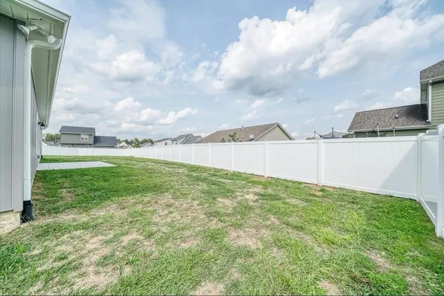 a view of a field and an ocean in the background