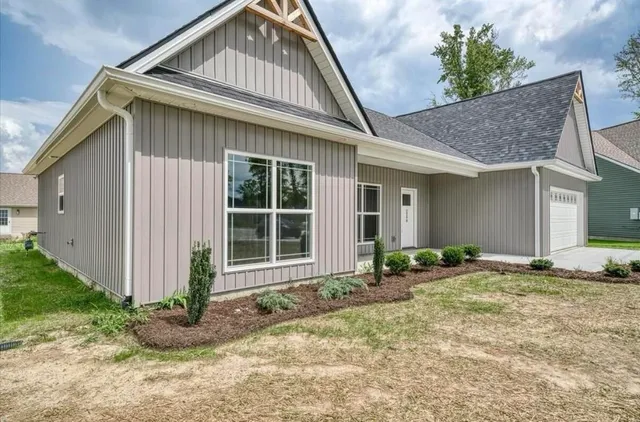 a front view of a house with garden