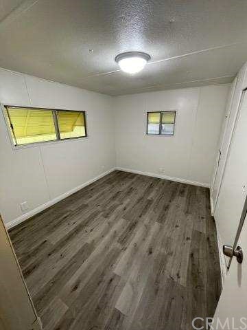 2345 190th, Unit 76 Redondo Beach, CA 90278 - Photo 9 of 10 an empty room with wooden floor and windows