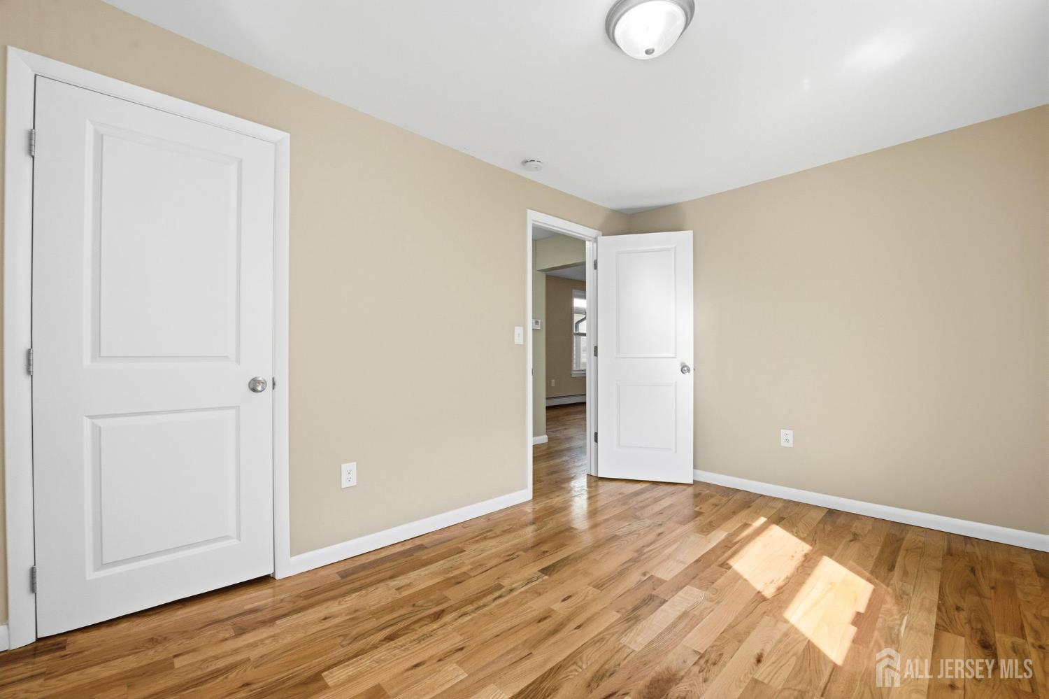 164 South Ridgewood Road, Unit 2 South Orange, NJ 07079 - Photo 14 of 19 a view of an empty room with wooden floor and closet