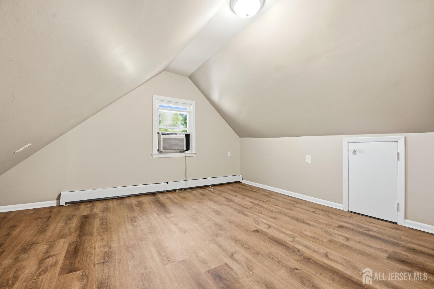 164 South Ridgewood Road, Unit 2 South Orange, NJ 07079 - Photo 15 of 19 an empty room with wooden floor and windows