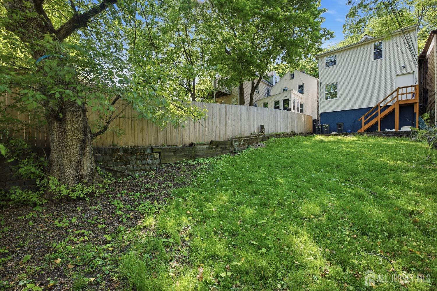 164 South Ridgewood Road, Unit 2 South Orange, NJ 07079 - Photo 19 of 19 a view of a backyard with plants and a large tree
