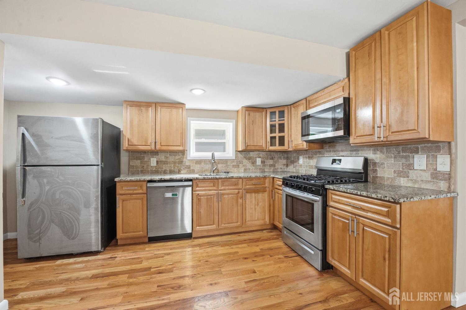 164 South Ridgewood Road, Unit 2 South Orange, NJ 07079 - Photo 5 of 19 a kitchen with granite countertop a refrigerator stove top oven and sink