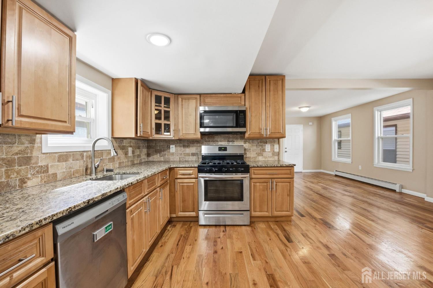 164 South Ridgewood Road, Unit 2 South Orange, NJ 07079 - Photo 6 of 19 a kitchen with granite countertop a sink cabinets and stainless steel appliances