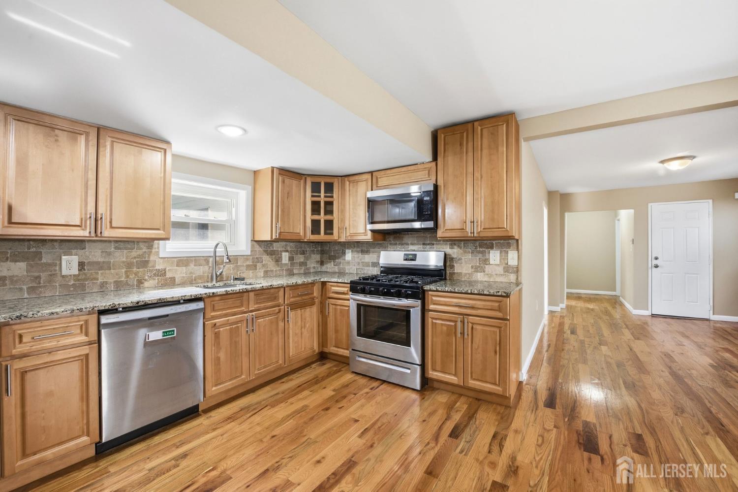 164 South Ridgewood Road, Unit 2 South Orange, NJ 07079 - Photo 7 of 19 a kitchen with granite countertop cabinets stainless steel appliances and a sink