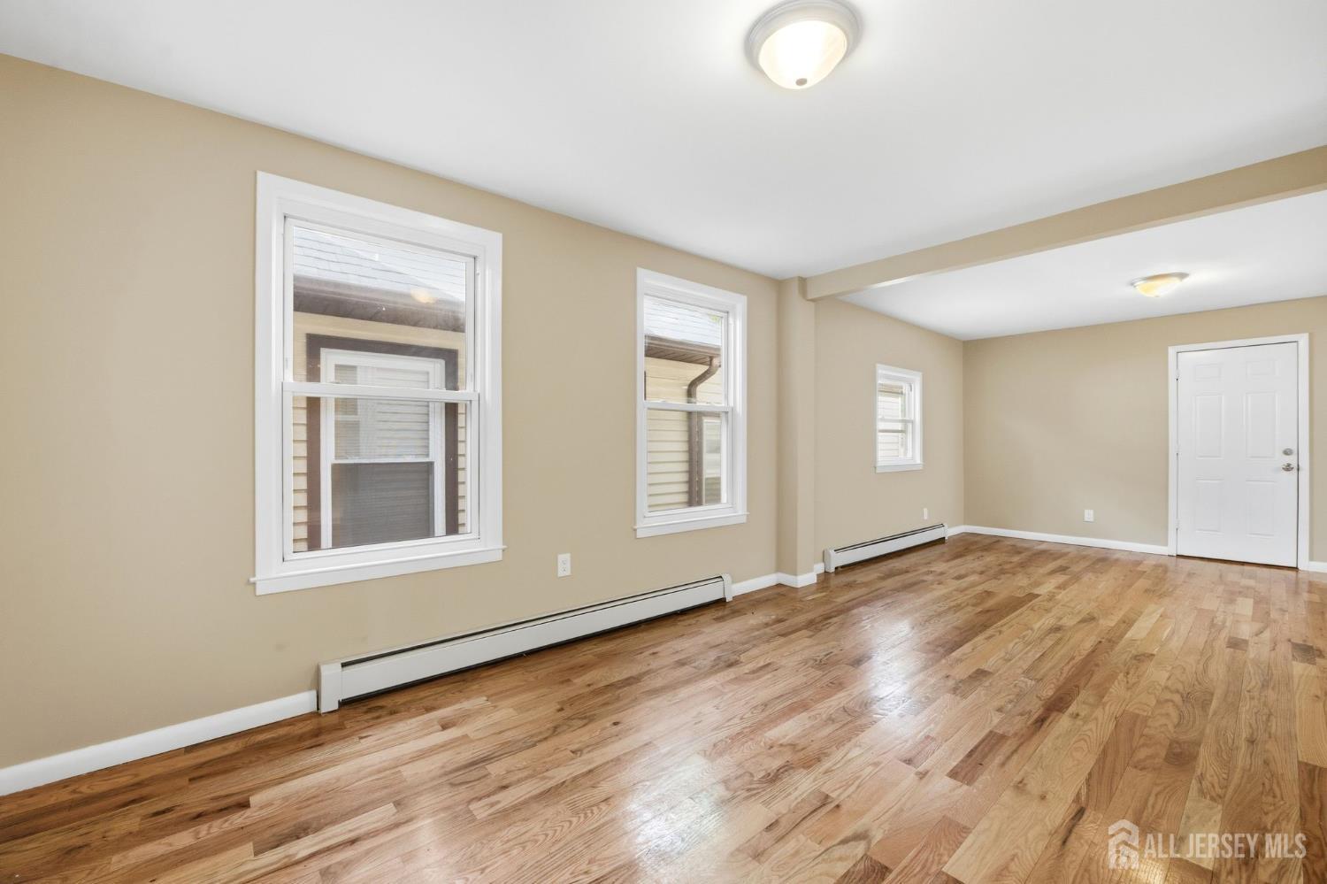 164 South Ridgewood Road, Unit 2 South Orange, NJ 07079 - Photo 9 of 19 a view of an empty room with wooden floor and a window