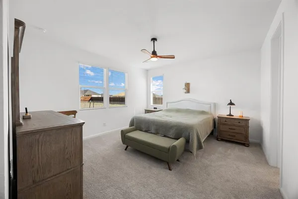 a spacious bedroom with a bed and window