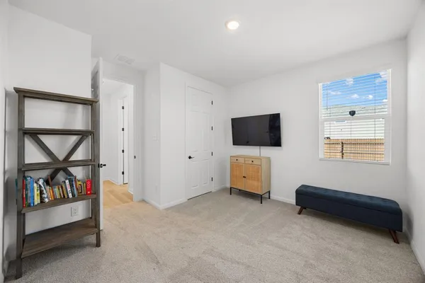 a view of a livingroom with furniture and a flat screen tv