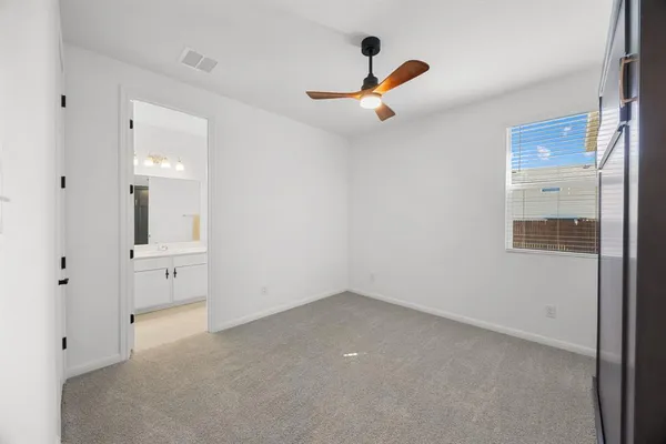 an empty room with closet and windows