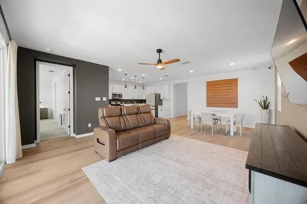 a living room with furniture and wooden floor