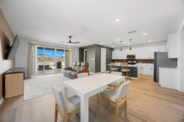 a large kitchen with a table and chairs