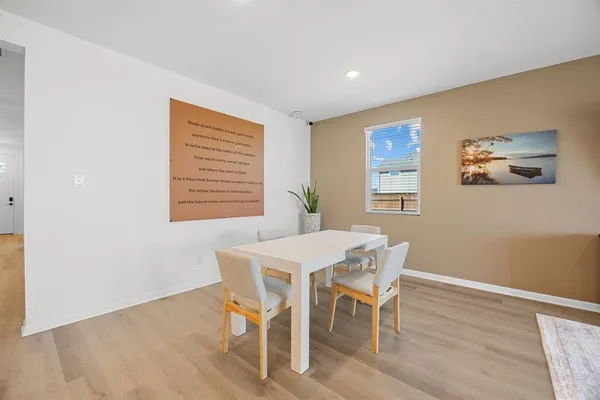 a view of a dining room with furniture and wooden floor