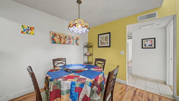 a view of a dining room with a table and chairs