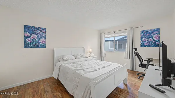 a bedroom with a bed and a desk
