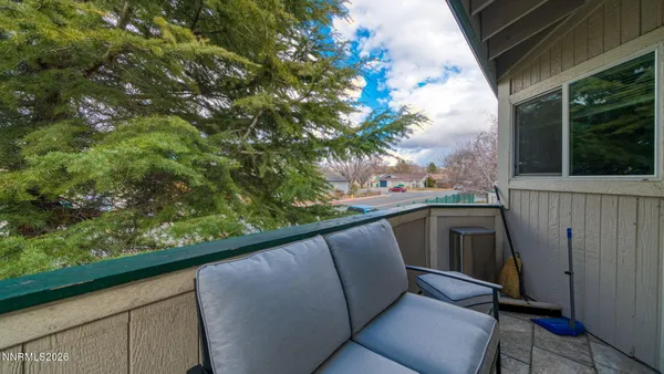 a view of balcony with furniture