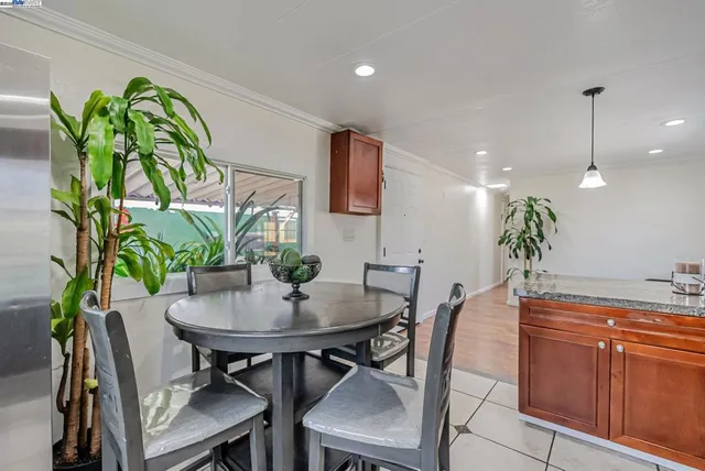 a view of a dining room with furniture and a potted plant