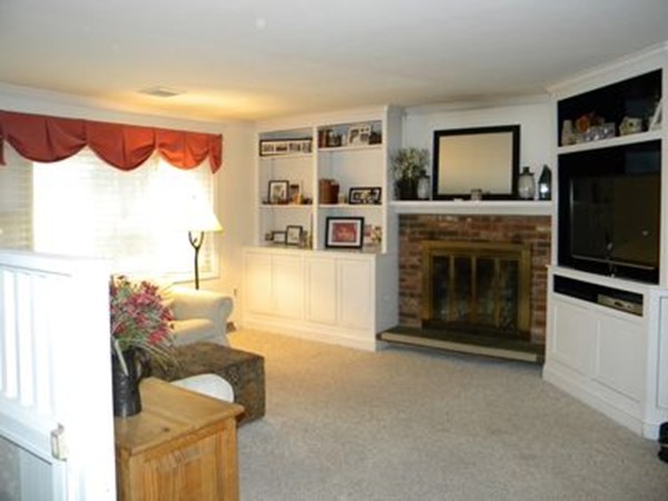 158 Hill Road Groton, MA 01450 - Photo 3 of 25 a living room with furniture a flat screen tv and a fireplace