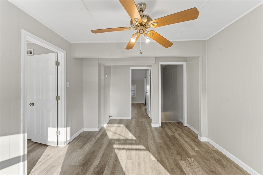130 Broadway Fall River, MA 02721 - Photo 21 of 42 a bedroom with a bed and a chandelier