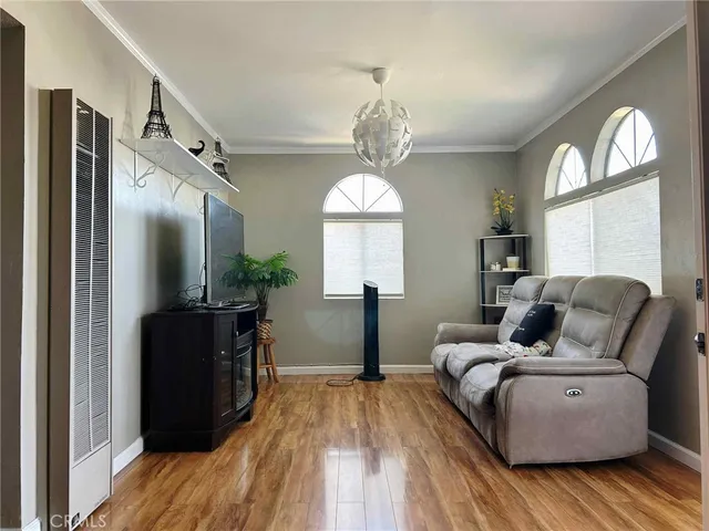 a living room with furniture and a chandelier