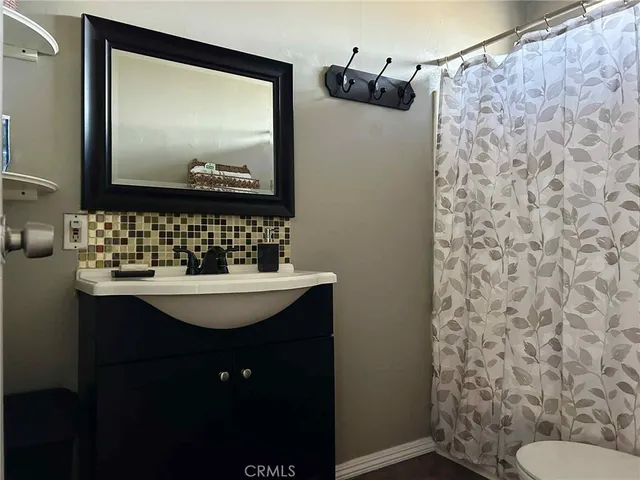 a bathroom with a sink toilet and mirror