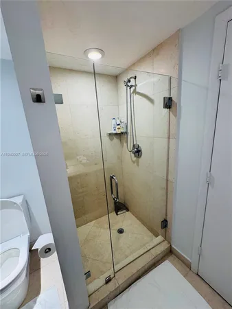 a bathroom with a shower and toilet