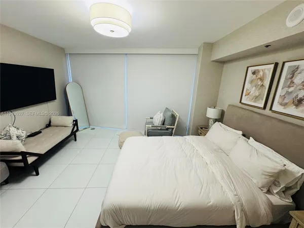 a bedroom with bed and window