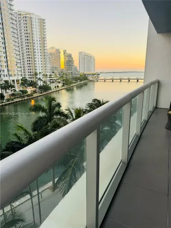 a view of swimming pool with outdoor seating and lake