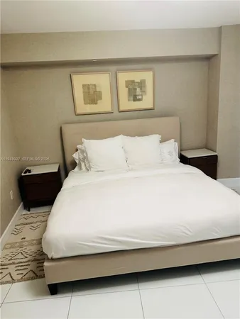 a bedroom with a bed and night stand