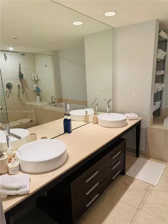 a bathroom with a sink double vanity and a mirror