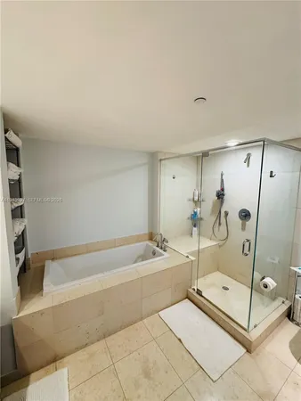 a bathroom with a tub and a shower