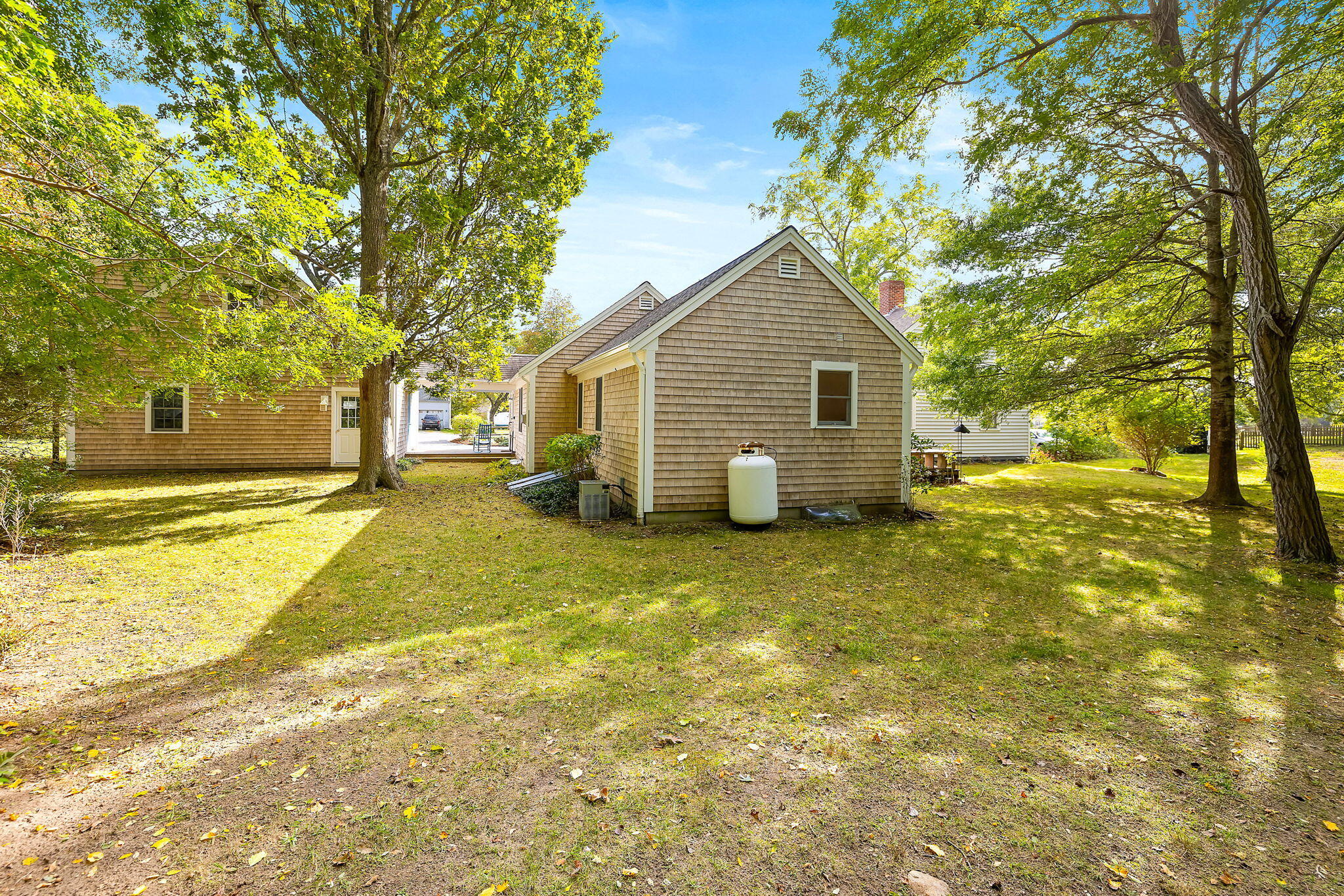 102 Portanimicut Road Orleans, MA 02653 - Photo 14 of 36 a view of a house with a backyard