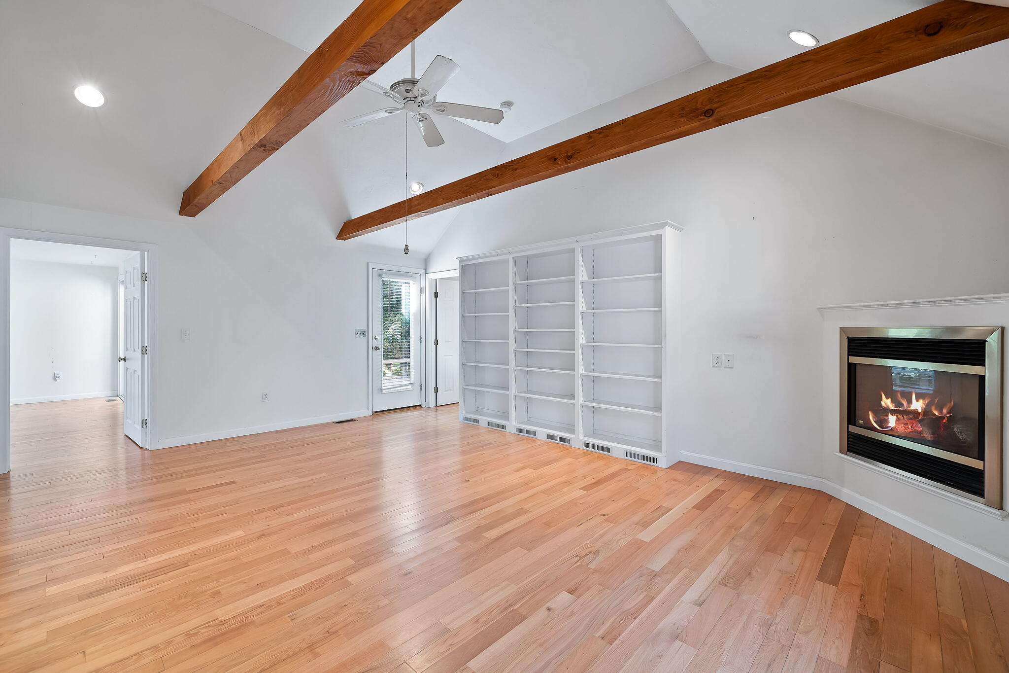 102 Portanimicut Road Orleans, MA 02653 - Photo 6 of 36 a view of an empty room with wooden floor and a window