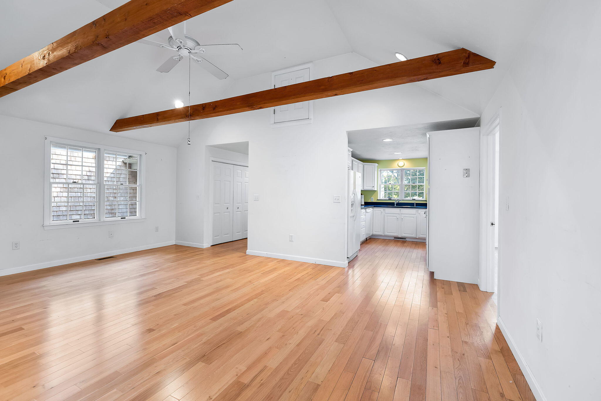102 Portanimicut Road Orleans, MA 02653 - Photo 7 of 36 a view of an empty room with wooden floor and a window