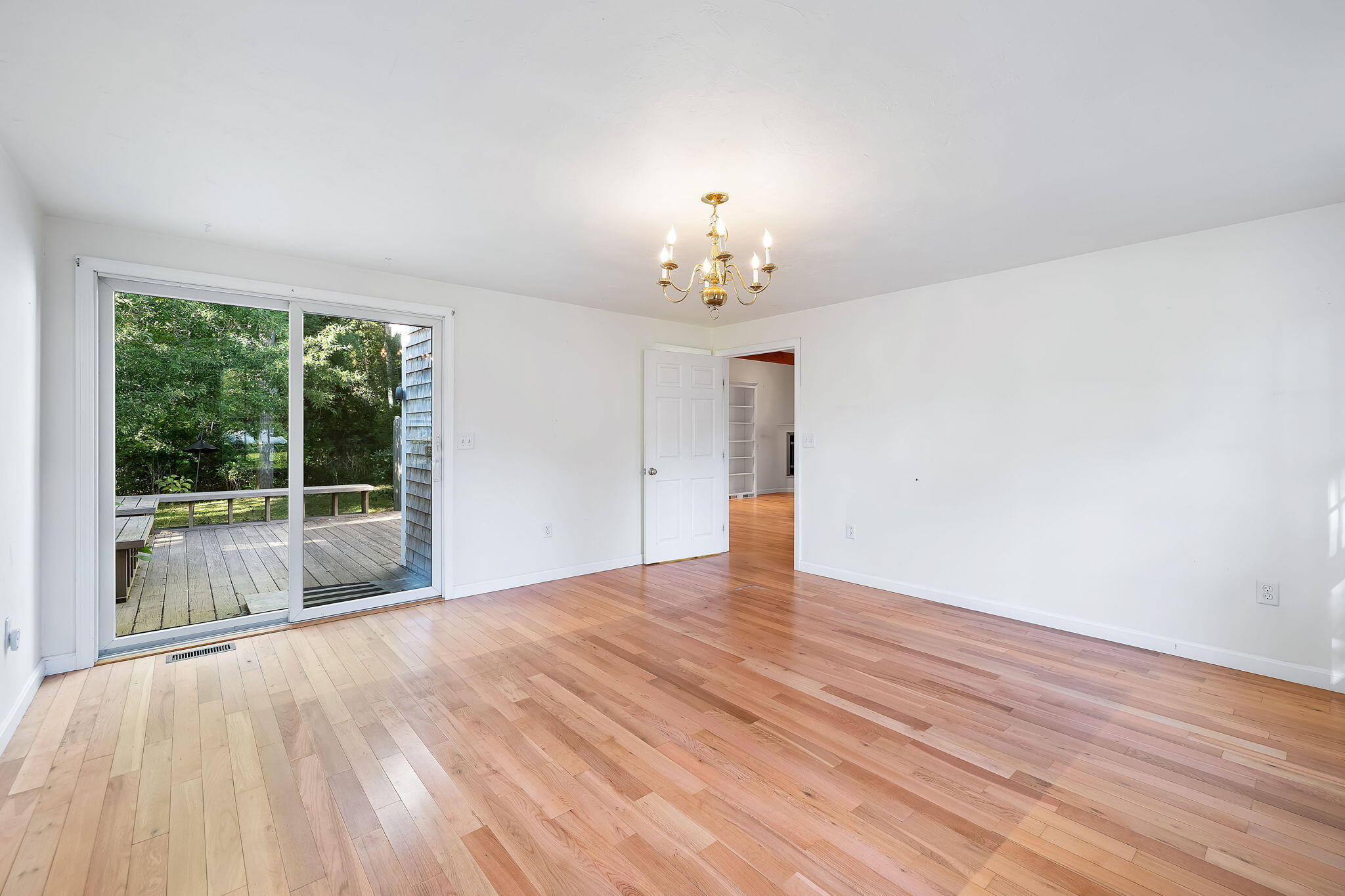 102 Portanimicut Road Orleans, MA 02653 - Photo 8 of 36 a view of an empty room with wooden floor and a window