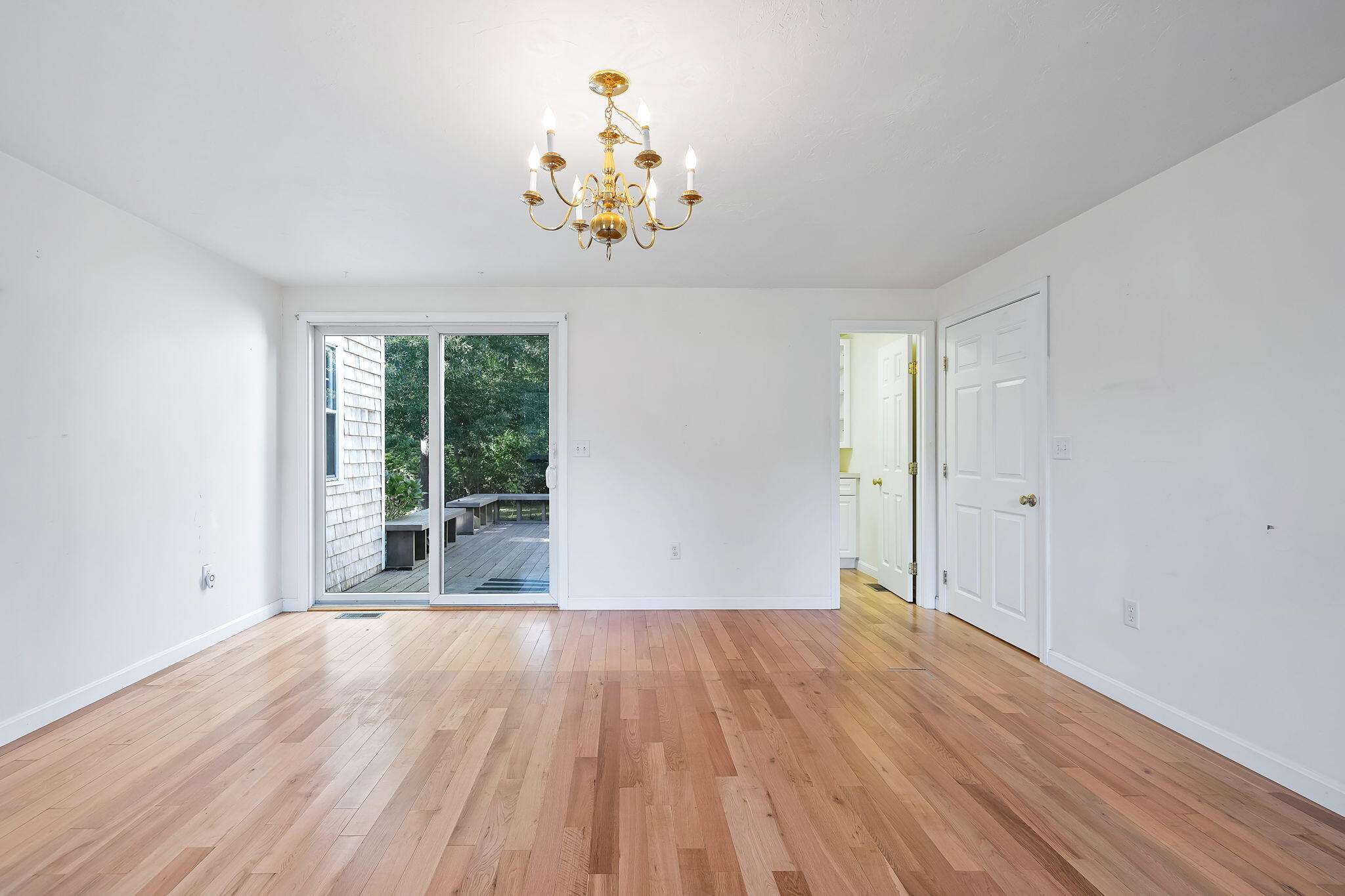 102 Portanimicut Road Orleans, MA 02653 - Photo 9 of 36 a view of a room with wooden floor and large windows