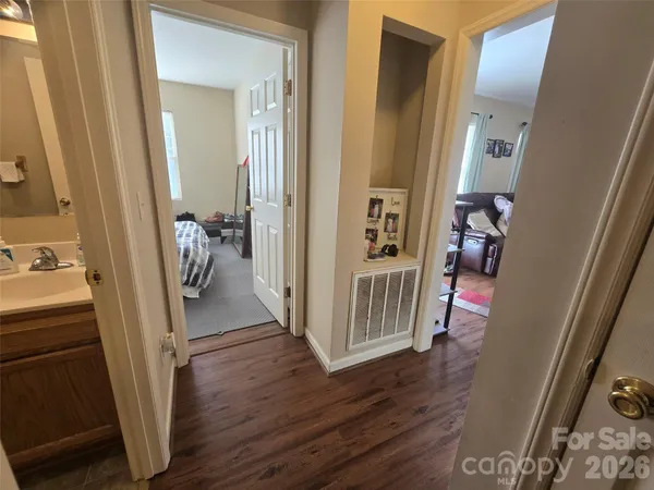 a view of a hallway view with wooden floor and furniture