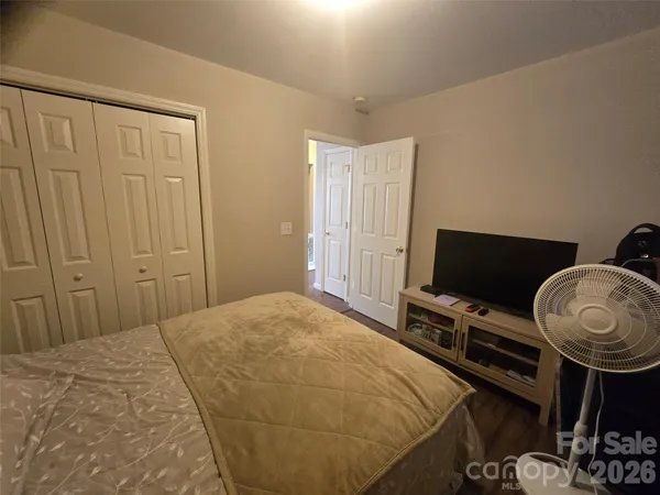 a bedroom with a bed and flat screen tv