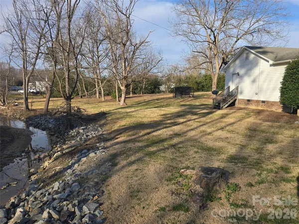 a view of a yard covered with snow in front of house