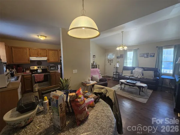 a living room with lots of furniture and kitchen view