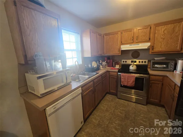 a kitchen with a sink and steel appliances