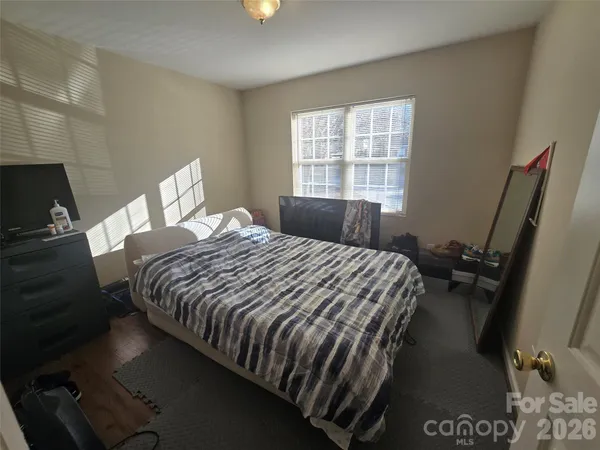 a bedroom with a bed next to a window