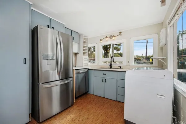 a kitchen with a refrigerator a sink and cabinets
